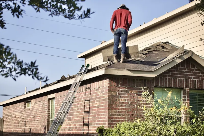 Professional roofer working on a residential roof in Paterson